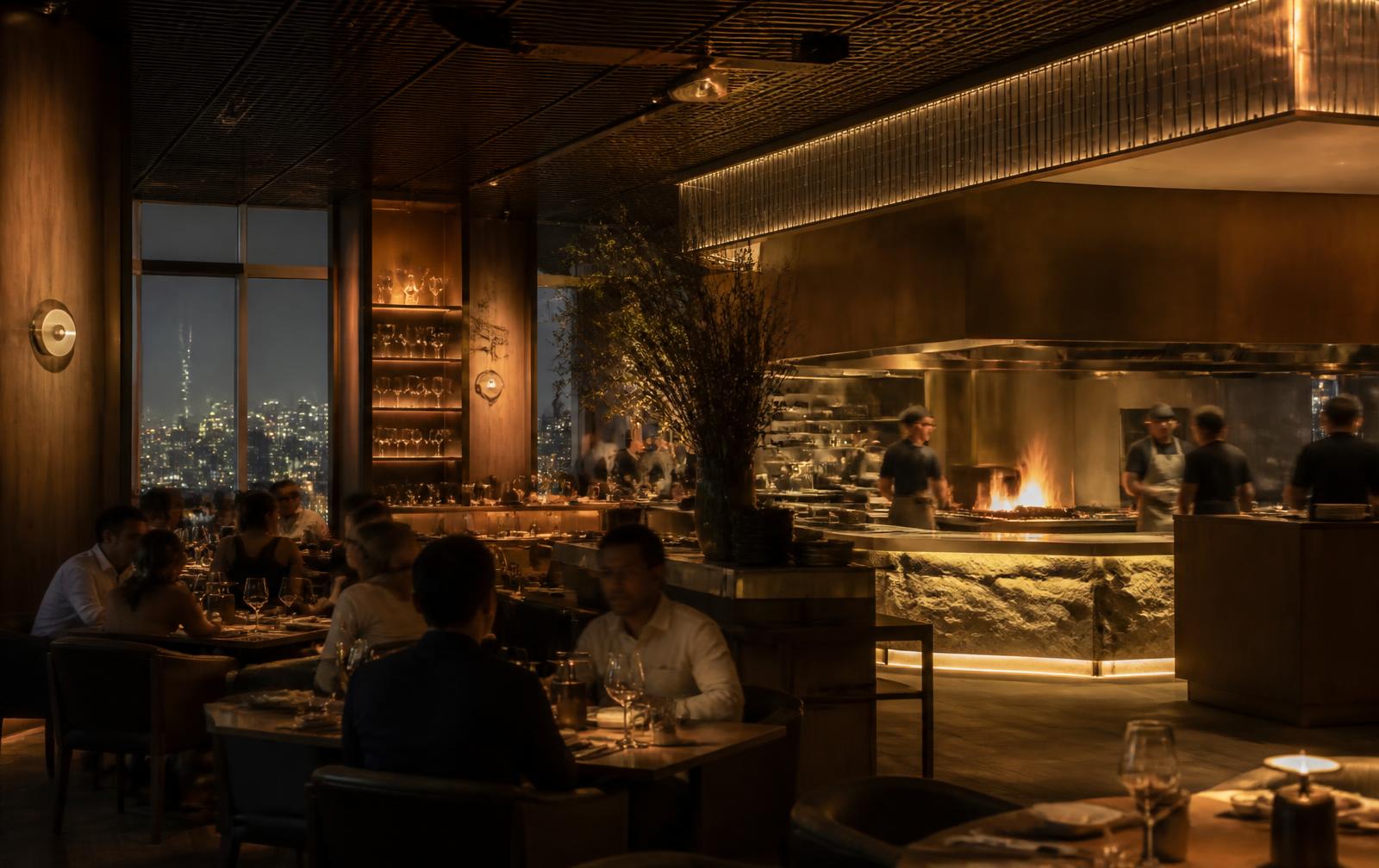 Warmly lit modern grill restaurant interior with open kitchen
